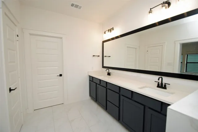 a large bed sitting in a bedroom next to a window and a chair