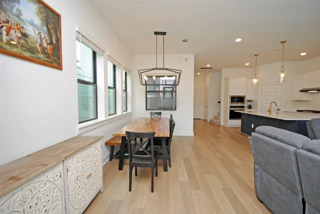 a view of a dining room with furniture window and wooden floor