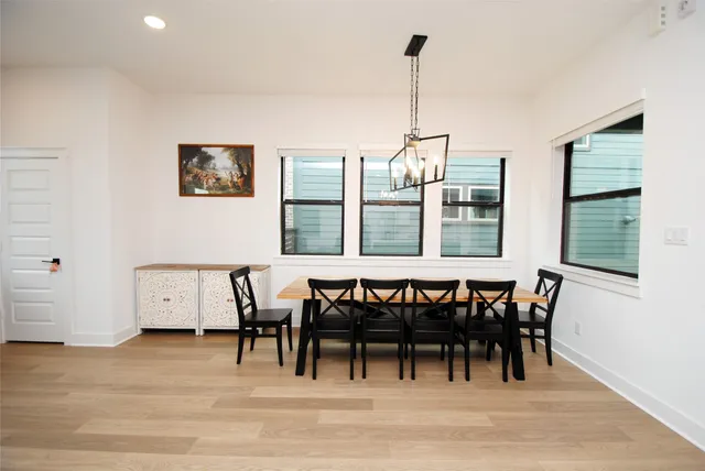 a view of a dining room with furniture window and wooden floor