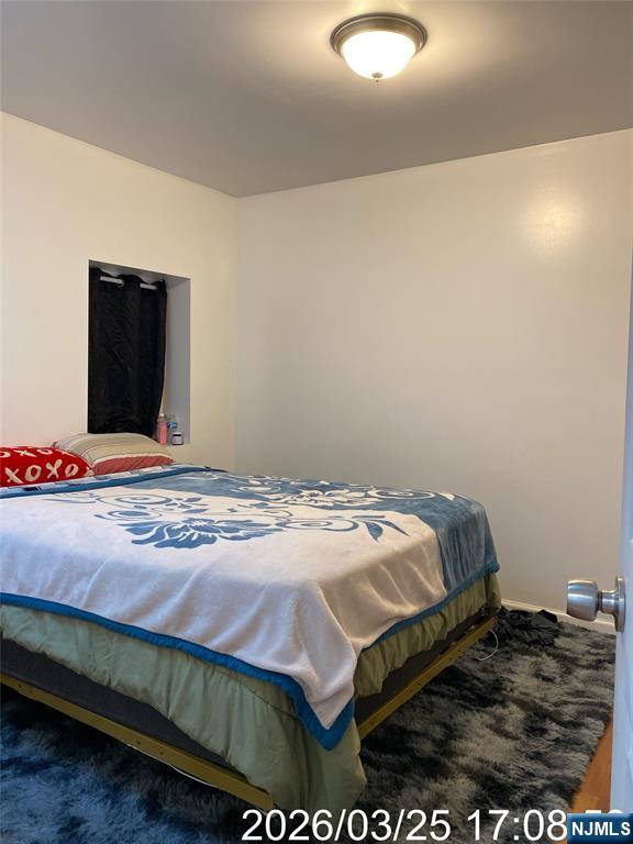 38 Delancy Street, Unit 3 Newark, NJ 07105 - Photo 13 of 16 a bedroom with a bed and a flat screen tv