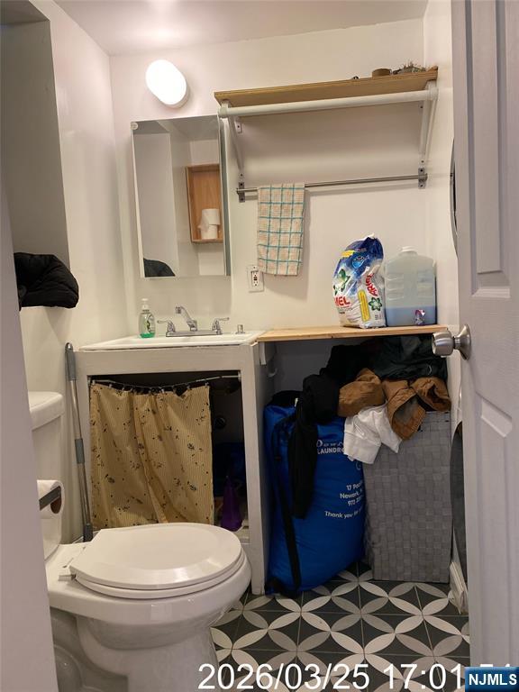 38 Delancy Street, Unit 3 Newark, NJ 07105 - Photo 4 of 16 a bathroom with a toilet a sink and view of bathroom