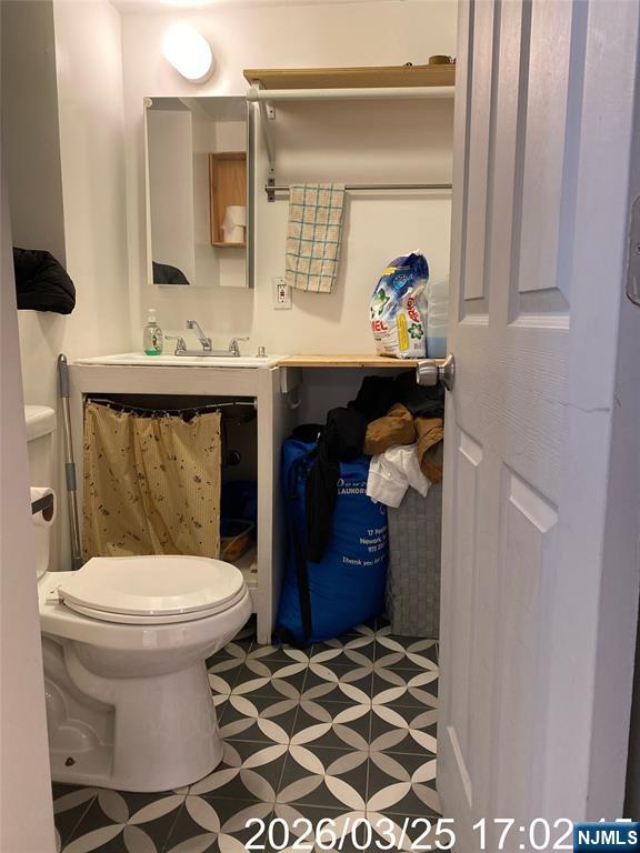 38 Delancy Street, Unit 3 Newark, NJ 07105 - Photo 6 of 16 a bathroom with a sink toilet and mirror