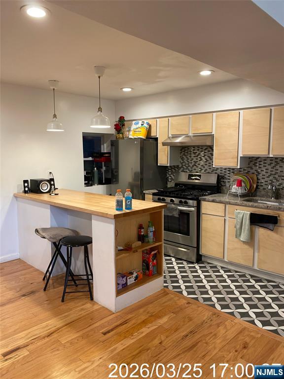 38 Delancy Street, Unit 3 Newark, NJ 07105 - Photo 7 of 16 a kitchen with stainless steel appliances kitchen island granite countertop a sink and a stove