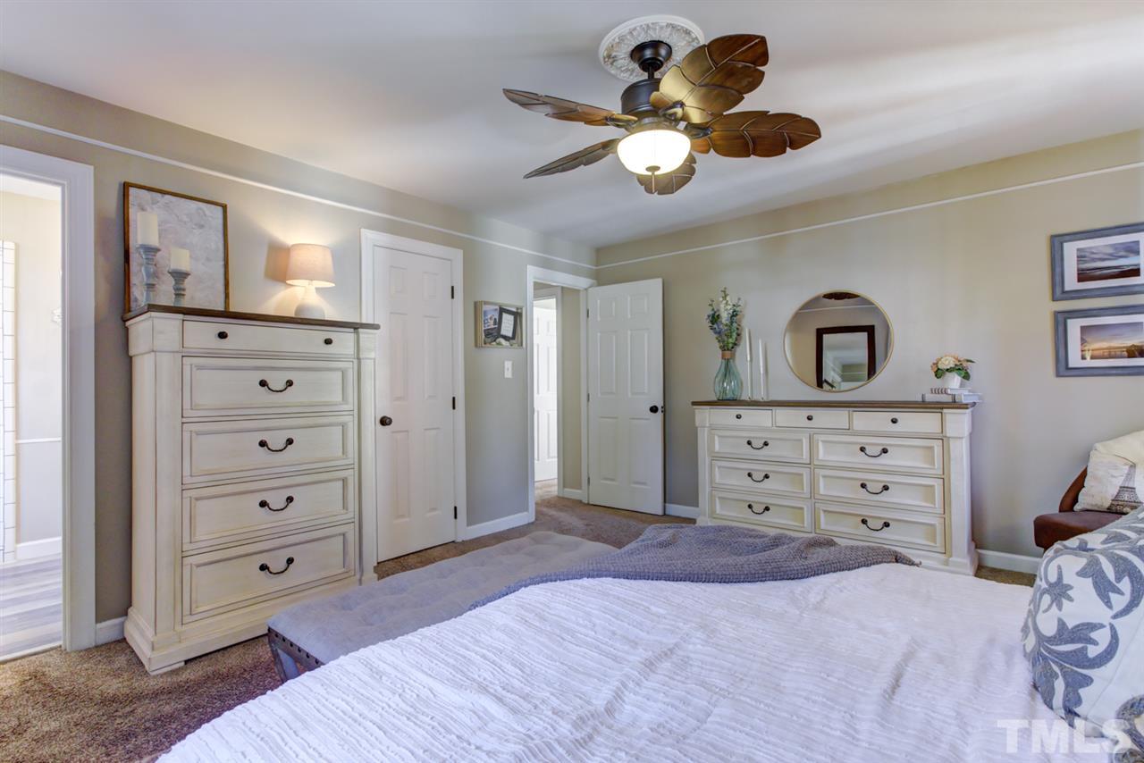 4417 Lancashire Drive Raleigh, NC 27613 - Photo 15 of 30 a bedroom with a bed and a dresser