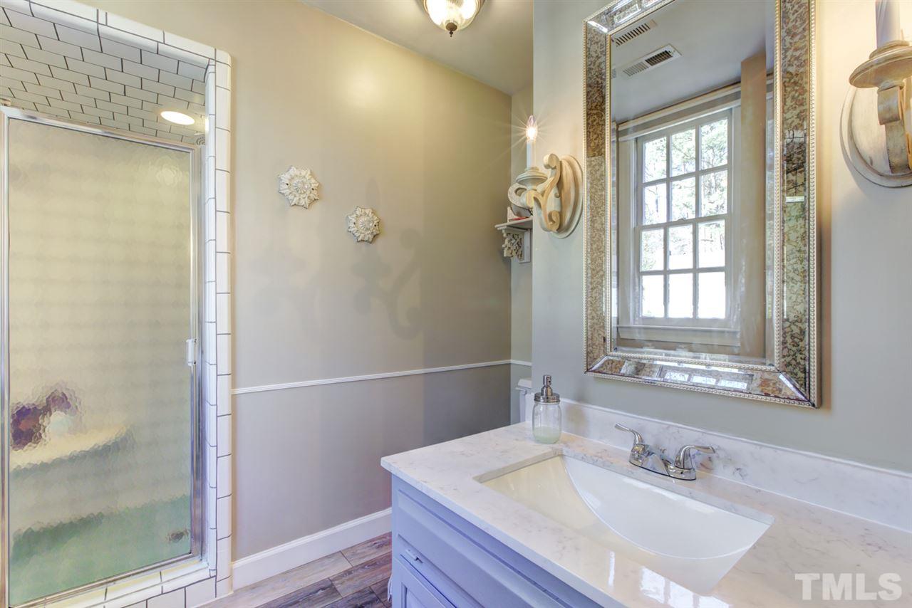4417 Lancashire Drive Raleigh, NC 27613 - Photo 16 of 30 a bathroom with a sink and a mirror