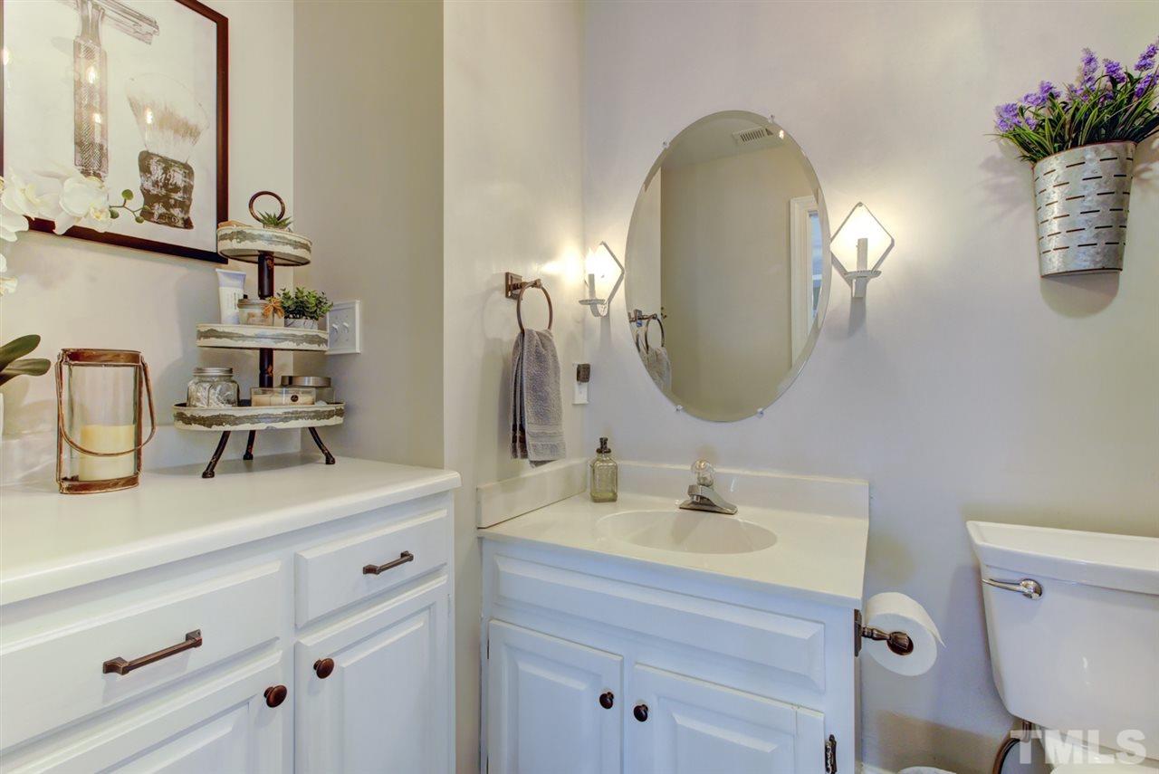 4417 Lancashire Drive Raleigh, NC 27613 - Photo 20 of 30 a bathroom with a sink mirror and toilet