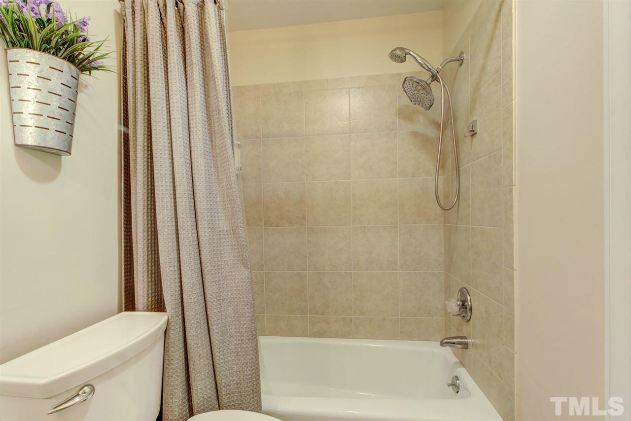 4417 Lancashire Drive Raleigh, NC 27613 - Photo 21 of 30 a bathroom with a shower and a toilet