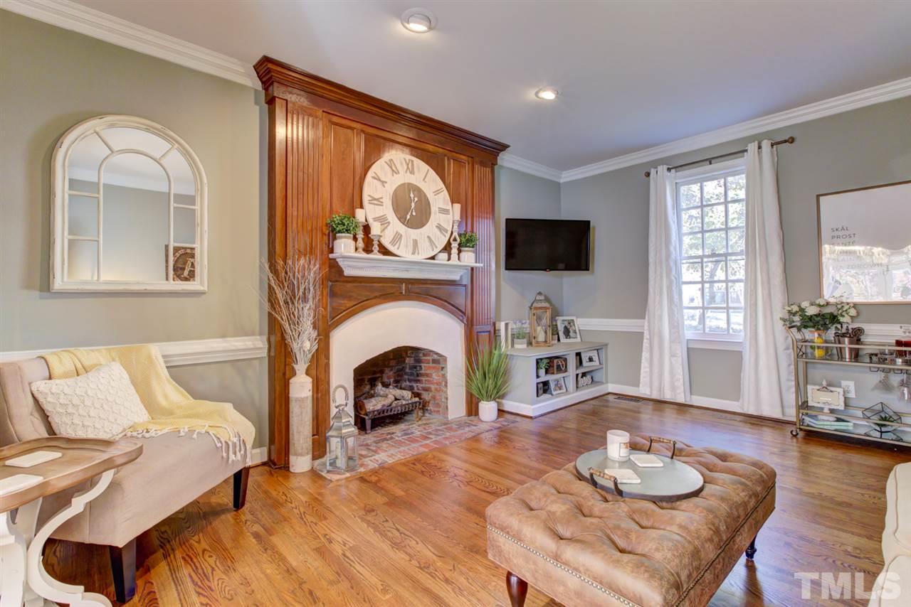 4417 Lancashire Drive Raleigh, NC 27613 - Photo 9 of 30 a living room with furniture fireplace and a flat screen tv