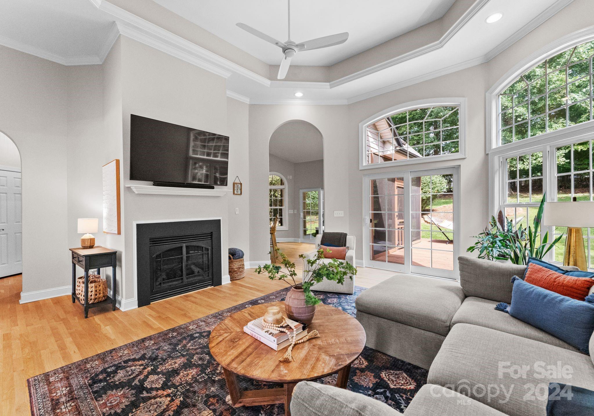 687 Normandy Road Mooresville, NC 28117 - Photo 13 of 32 a living room with furniture a fireplace and a flat screen tv
