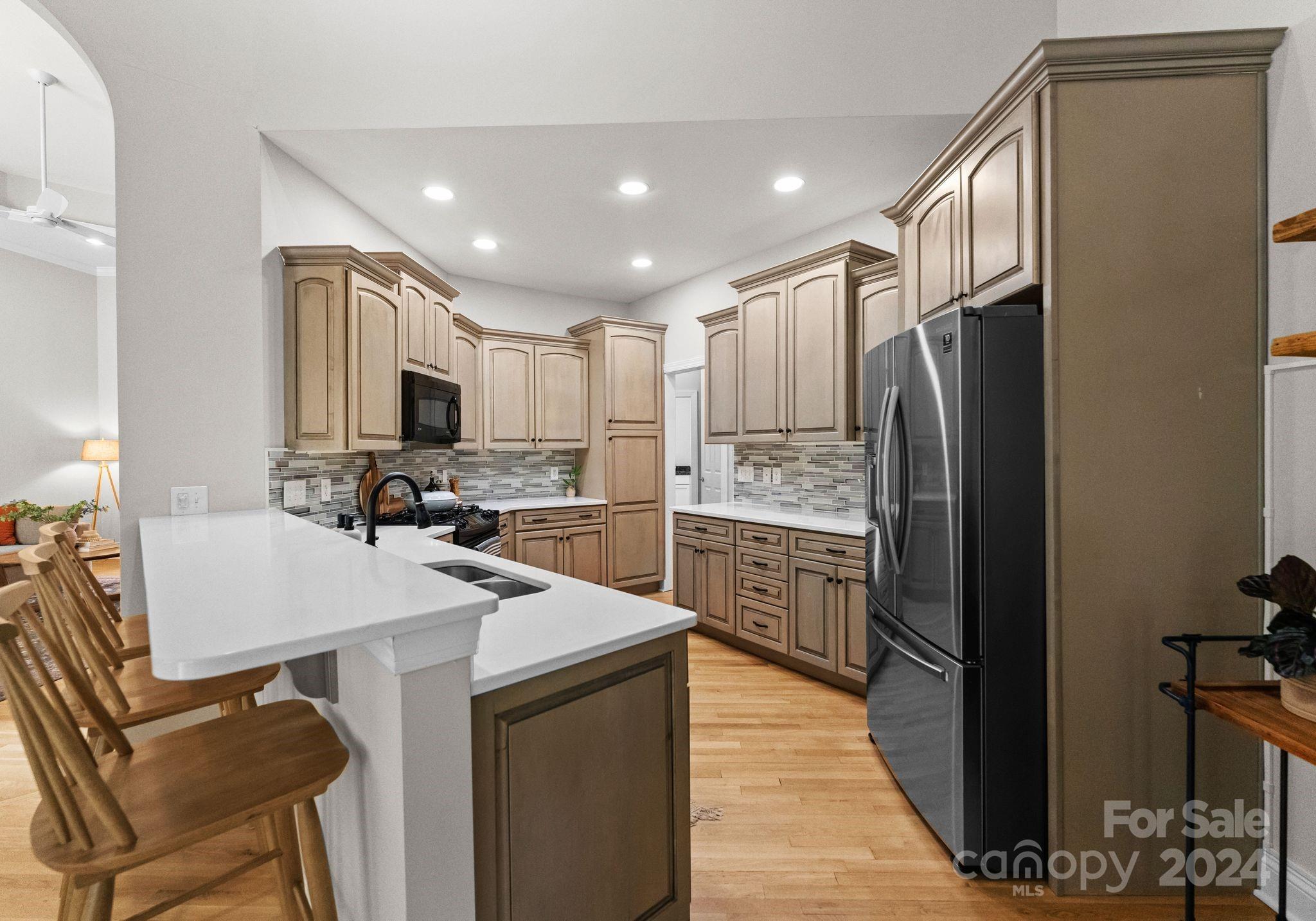 687 Normandy Road Mooresville, NC 28117 - Photo 16 of 32 a kitchen with a refrigerator a sink and a stove top oven