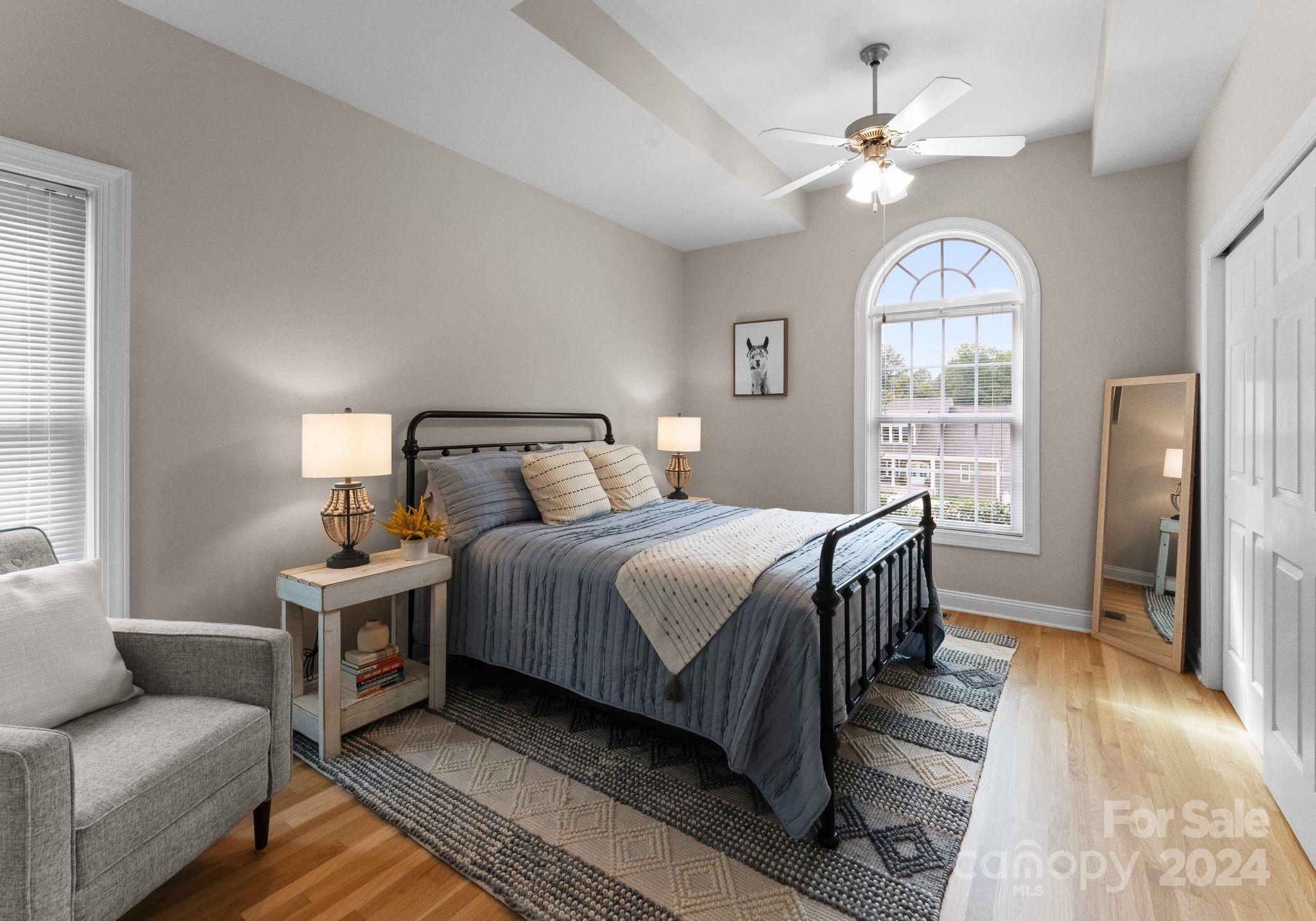 687 Normandy Road Mooresville, NC 28117 - Photo 25 of 32 a bedroom with a bed and a chandelier