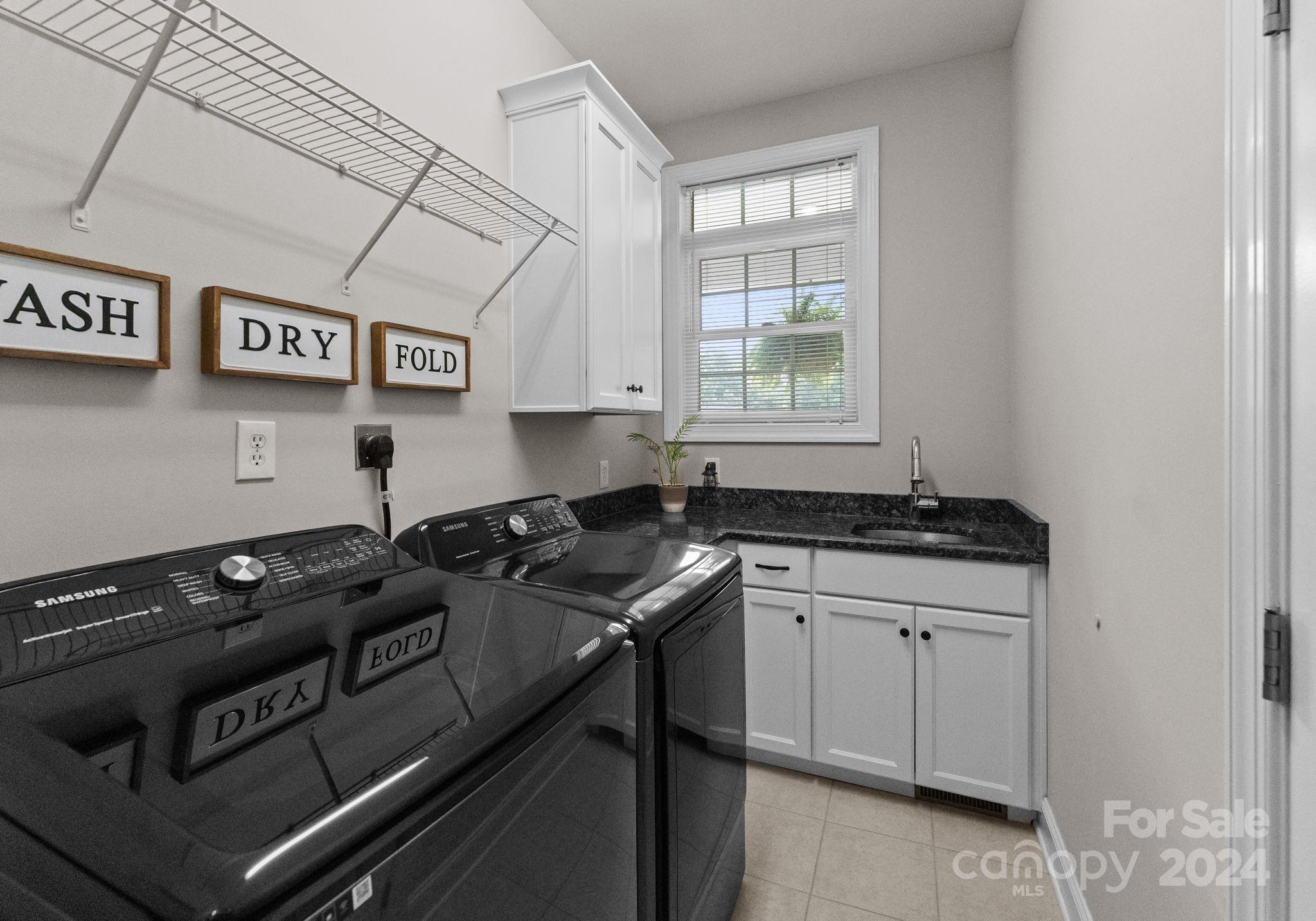687 Normandy Road Mooresville, NC 28117 - Photo 28 of 32 a kitchen with granite countertop a stove and a sink