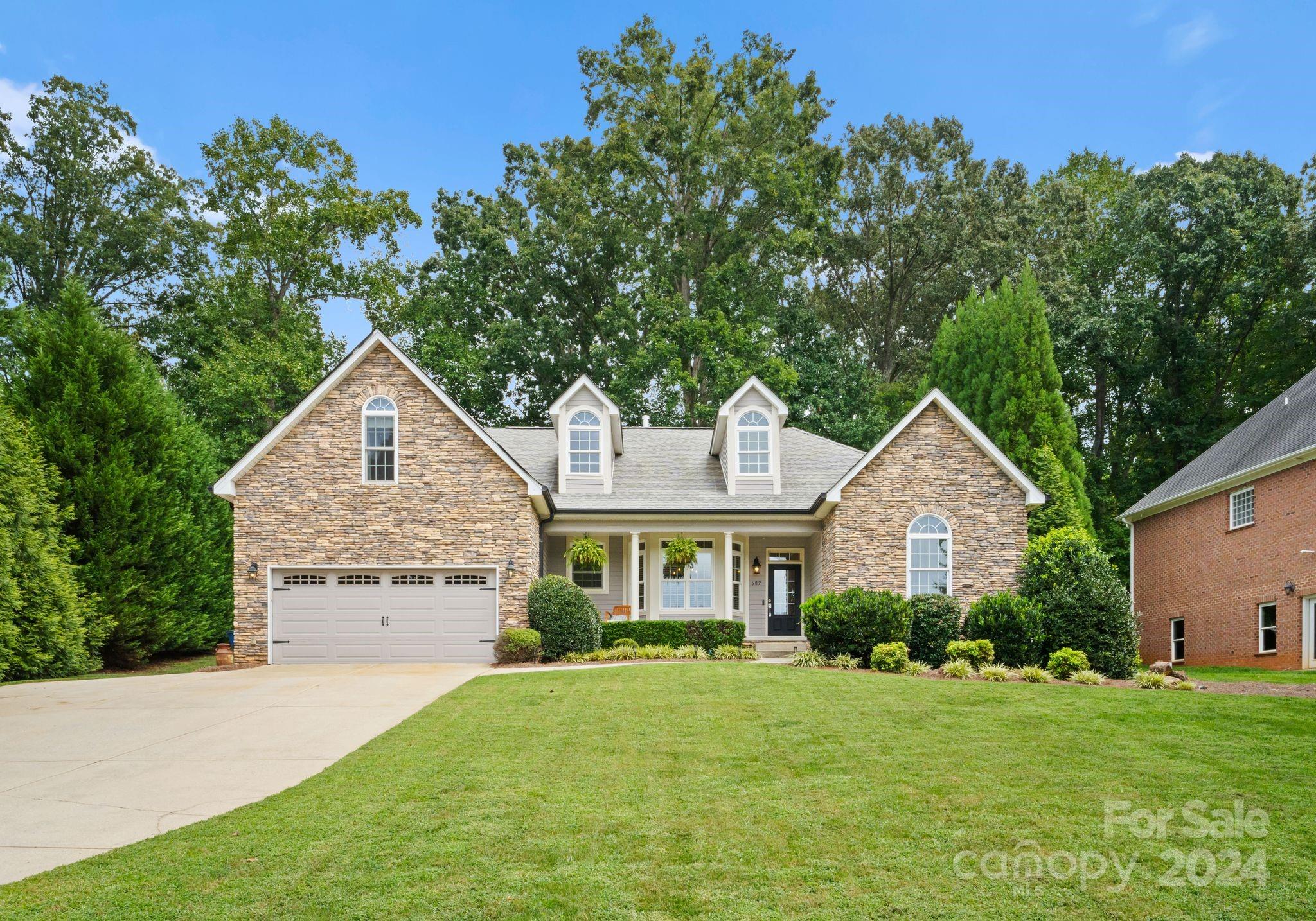 687 Normandy Road Mooresville, NC 28117 - Photo 5 of 32 a front view of a house with a yard and garage