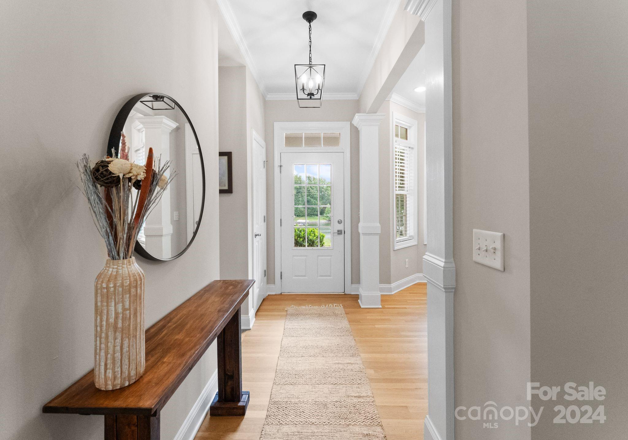 687 Normandy Road Mooresville, NC 28117 - Photo 8 of 32 a view of a hallway with entryway wooden floor and front door