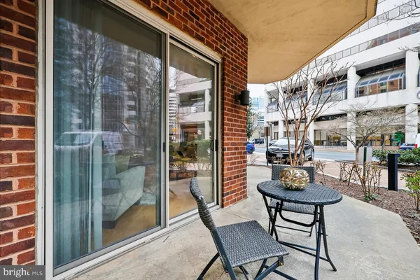 a view of a patio with a table and chairs