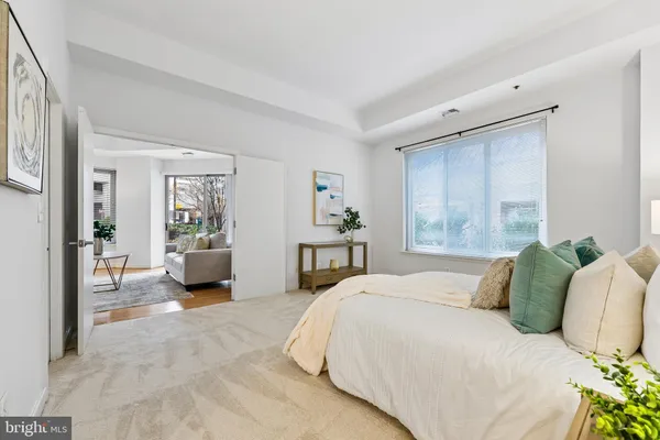 a bedroom with a large bed and a chandelier