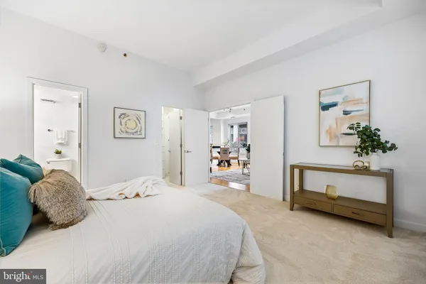 a bedroom with a bed and a dresser