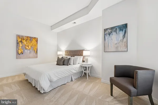 a bedroom with a bed and a couch