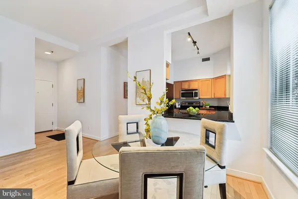 a living room with furniture a flat screen tv and a table