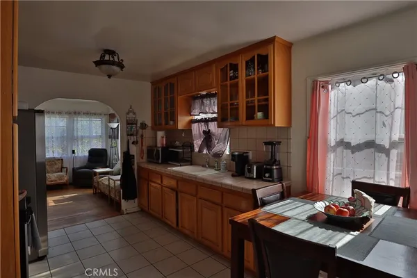 a bedroom with furniture a chandelier and a window