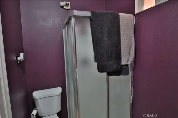 a bathroom with a toilet and a shower