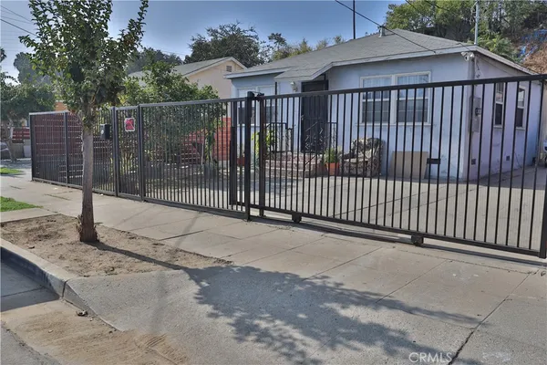 a view of a house with a wooden fence