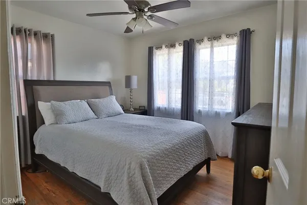 a bedroom with a large bed and a window