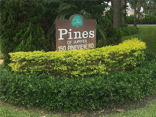 150 Pineview Road, Unit D7 Jupiter, FL 33469 - Photo 1 of 16 a view of a tree in a yard