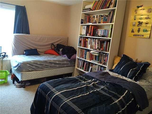 150 Pineview Road, Unit D7 Jupiter, FL 33469 - Photo 7 of 16 a bedroom with a bed and a book shelf