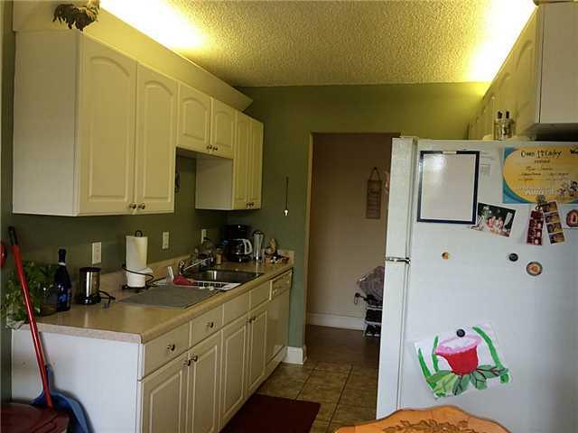 150 Pineview Road, Unit D7 Jupiter, FL 33469 - Photo 9 of 16 a kitchen with a sink cabinets and utility room