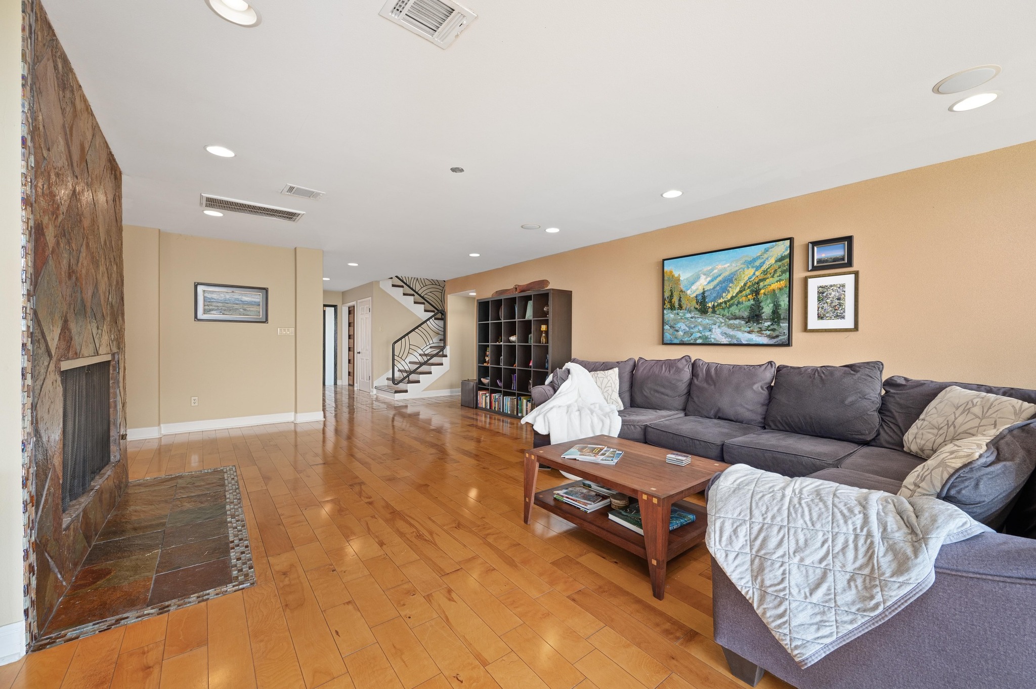 6507 Mesa Drive Austin, TX 78731 - Photo 11 of 40 Living area with stairs, light wood-style flooring, recessed lighting, and a fireplace