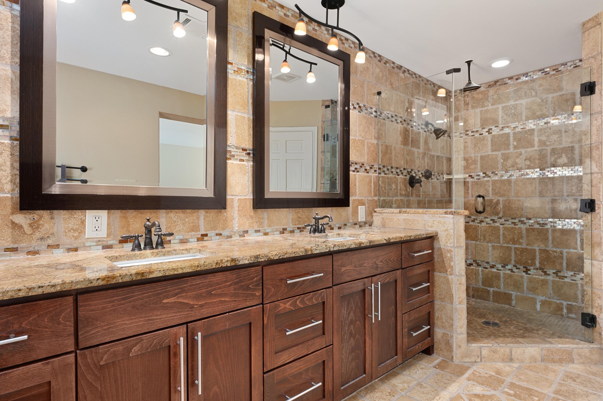 6507 Mesa Drive Austin, TX 78731 - Photo 19 of 40 Full bathroom with double vanity, a stall shower, tile walls, and backsplash