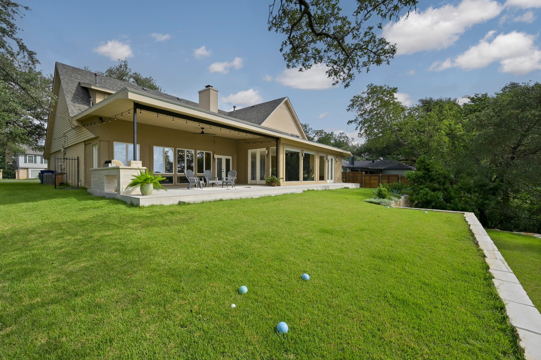 6507 Mesa Drive Austin, TX 78731 - Photo 29 of 40 Back of property with a patio area, a chimney, and a shingled roof