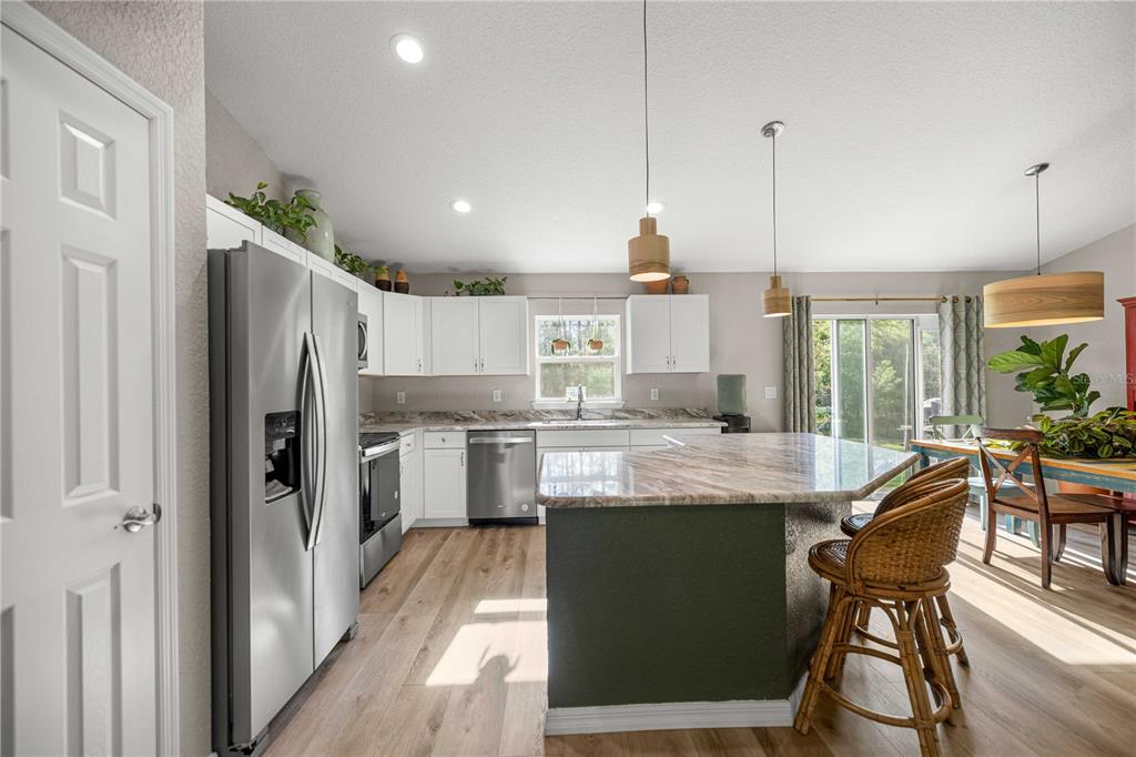 279 Southwest Fig Tree Lane Dunnellon, FL 34431 - Photo 11 of 33 a kitchen with stainless steel appliances granite countertop counter space and wooden floor