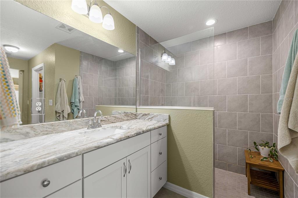 279 Southwest Fig Tree Lane Dunnellon, FL 34431 - Photo 17 of 33 a bathroom with a granite countertop sink a mirror and a