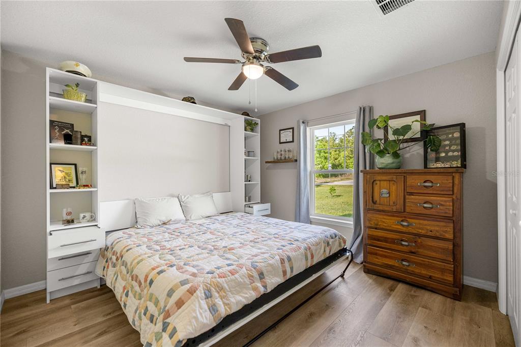 279 Southwest Fig Tree Lane Dunnellon, FL 34431 - Photo 19 of 33 a bedroom with a bed and a dresser