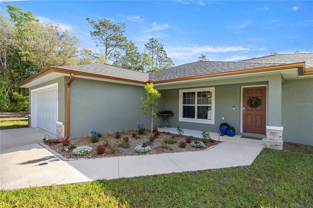 279 Southwest Fig Tree Lane Dunnellon, FL 34431 - Photo 2 of 33 a front view of a house with a yard