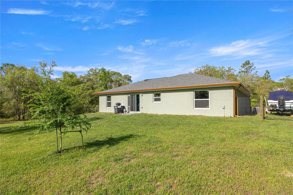 279 Southwest Fig Tree Lane Dunnellon, FL 34431 - Photo 27 of 33 a view of a yard in front of a house with a large tree