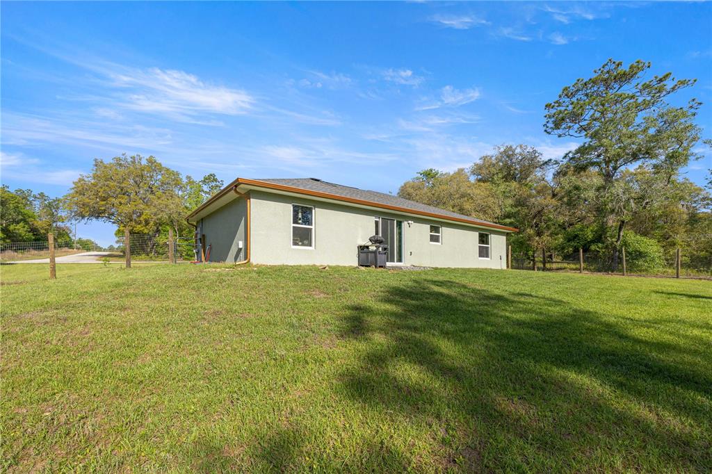 279 Southwest Fig Tree Lane Dunnellon, FL 34431 - Photo 28 of 33 a view of a house with a big yard