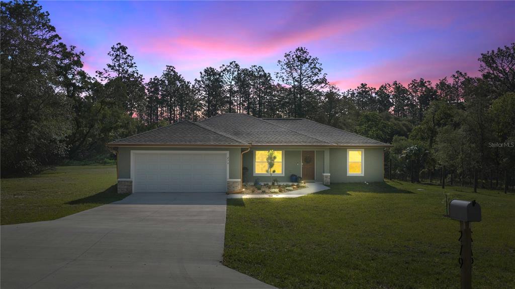 279 Southwest Fig Tree Lane Dunnellon, FL 34431 - Photo 4 of 33 a front view of a house with yard and green space