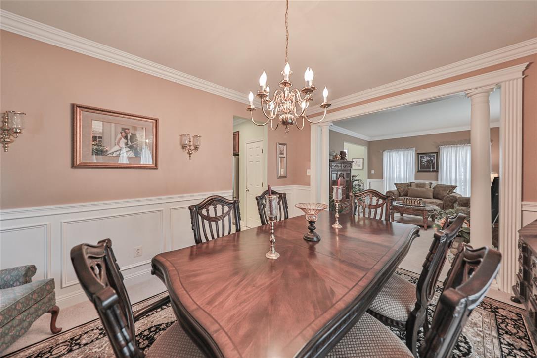 138 Clover Hollow Road Easton, PA 18045 - Photo 15 of 95 An elegant dining room, framed by classic columns, seamlessly transitions into a comfortable living area.