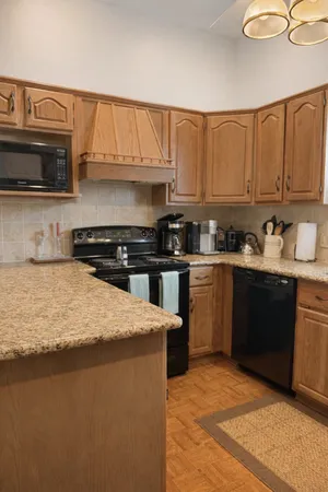 a kitchen with stainless steel appliances granite countertop a sink stove and microwave