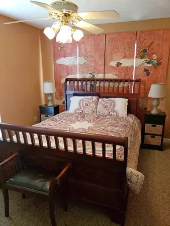 a bedroom with a bed and a window