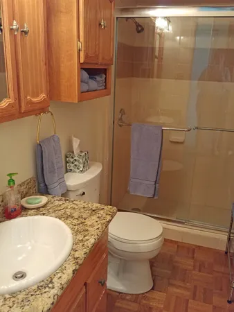 a bathroom with a sink toilet and shower
