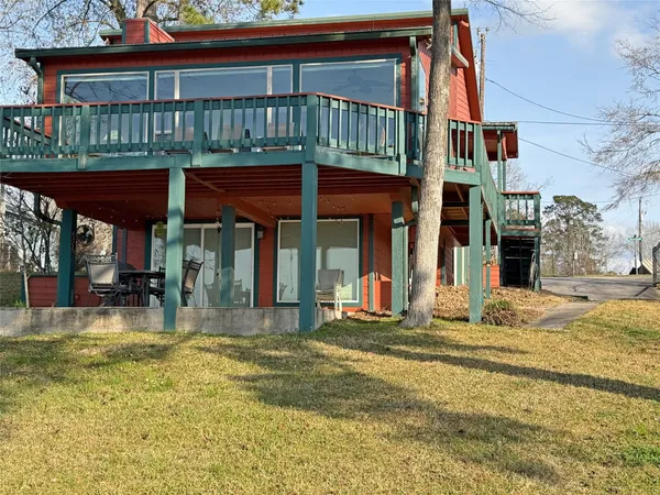 a view of a house with a yard patio and deck