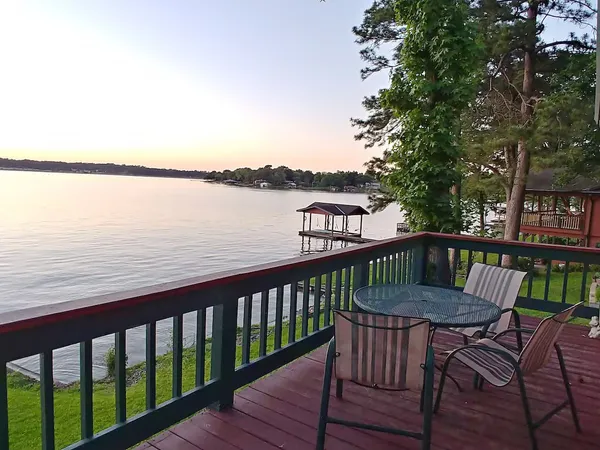 a view of a two chairs and table on the deck