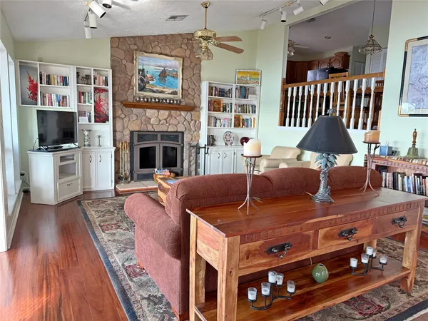 a living room with furniture a flat screen tv and a fireplace