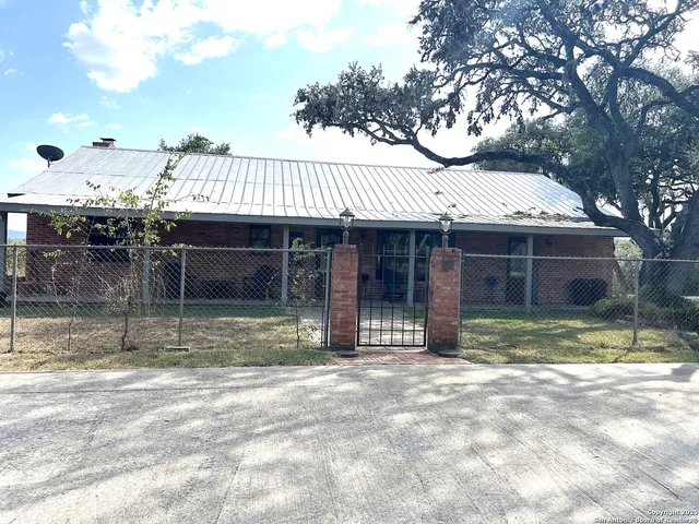 a living room with furniture a large window and a fireplace