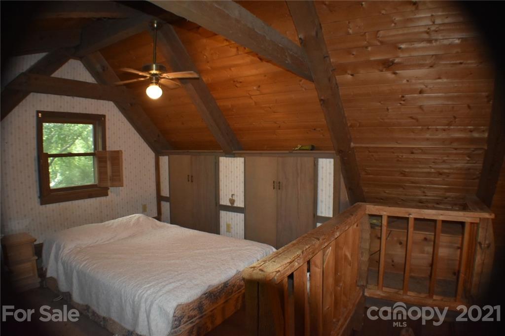 3670 Union Road Gastonia, NC 28056 - Photo 37 of 41 a bedroom with a bed and a chandelier