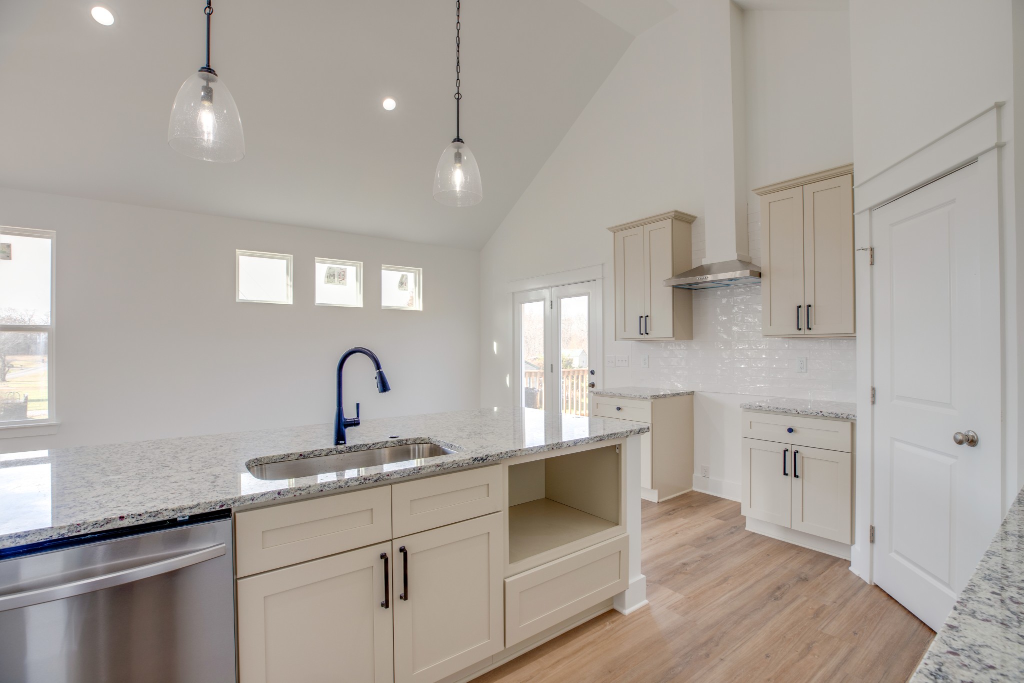 2802 Lock Hollow Road Dickson, TN 37055 - Photo 14 of 34 a kitchen with kitchen island white cabinets and sink